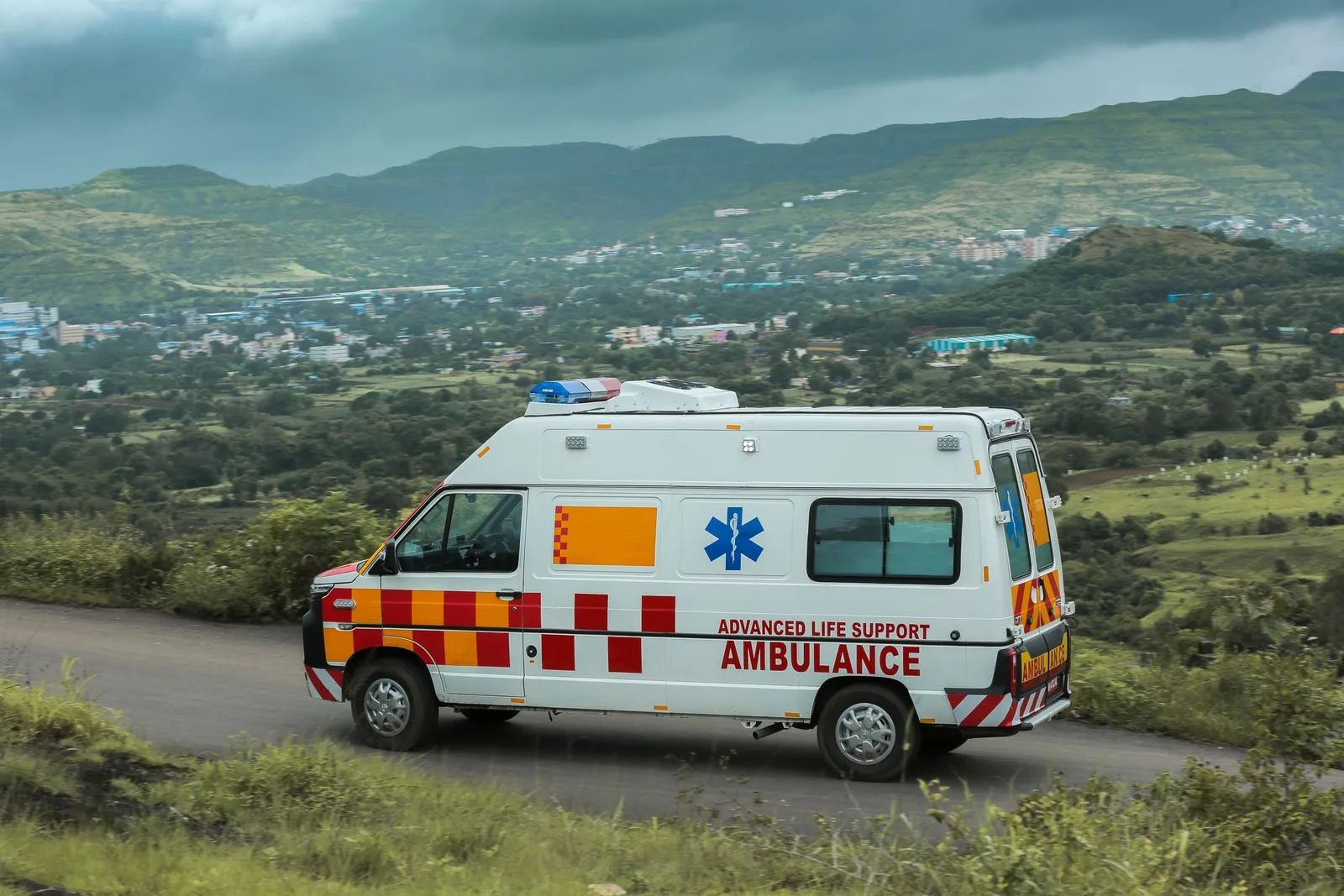 An advanced life support ambulance on a hill road near Pune.