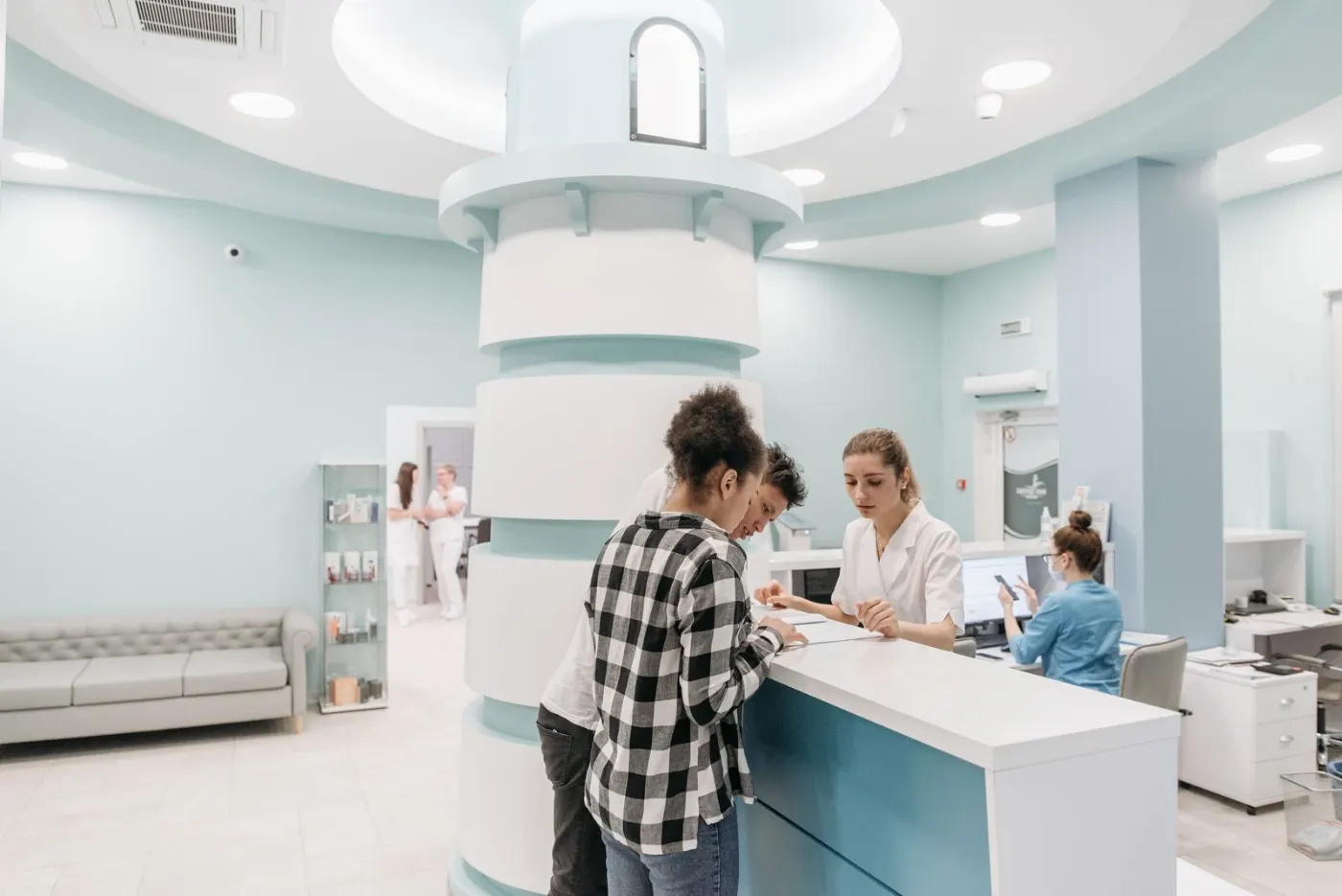 A receptionist registering a patient at a hospital front desk