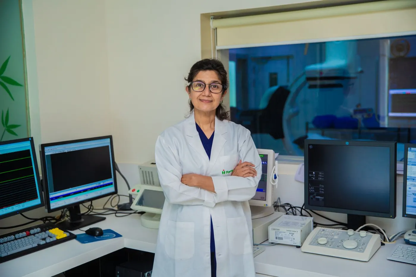 A doctor standing at her workstation in a Delhi medical lab.