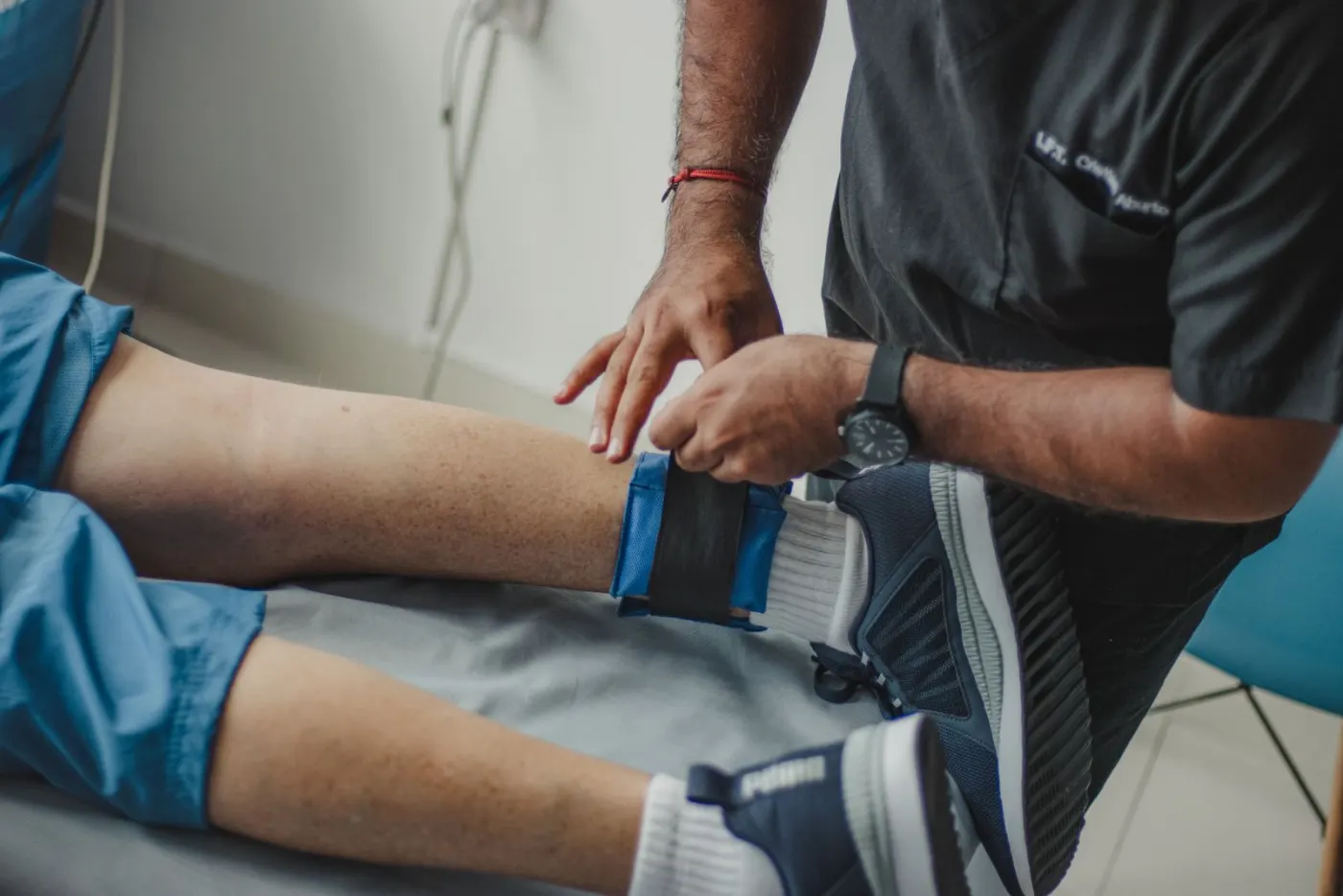 A physiotherapist helping a patient with a leg exercise